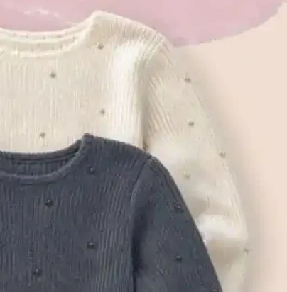 Maglione con baschina e perle